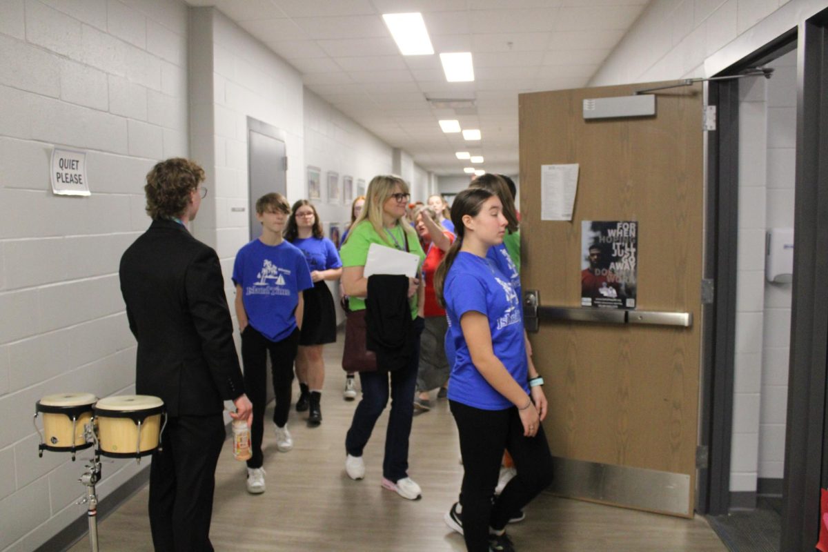 A middle school show choir group is led to the warm-up room. They are going to perform at the Northern Lights competition on January 27, 2024.