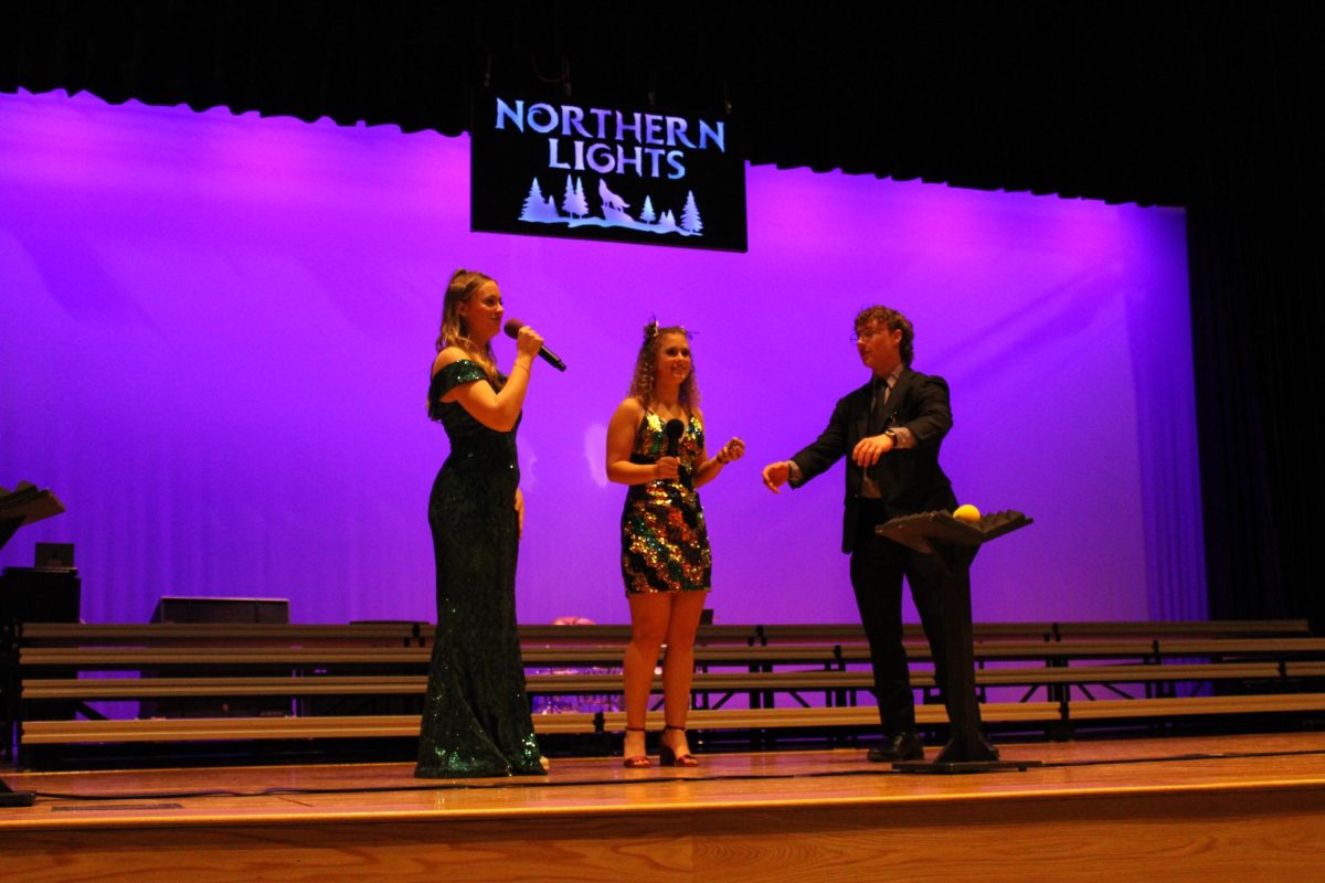 Seniors Ava Johnson, Aidan Clarys, and Kaitlyn Wagner announce the next middle school group to perform. They are the hosts of the Northern Lights competition on January 27, 2024.