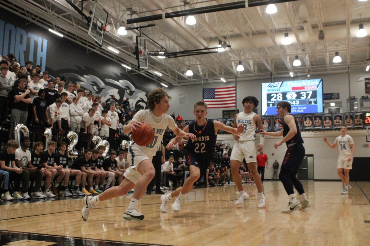 Freshman Kellen Murphy (10) blows past his defender on the baseline off of a pass from Junior Nike Orgilbold(13). Shortly after, Murphy made an impressive layup over two defenders to close the gap to just 7 points against the Norris Titans on Feb 9, 2024.