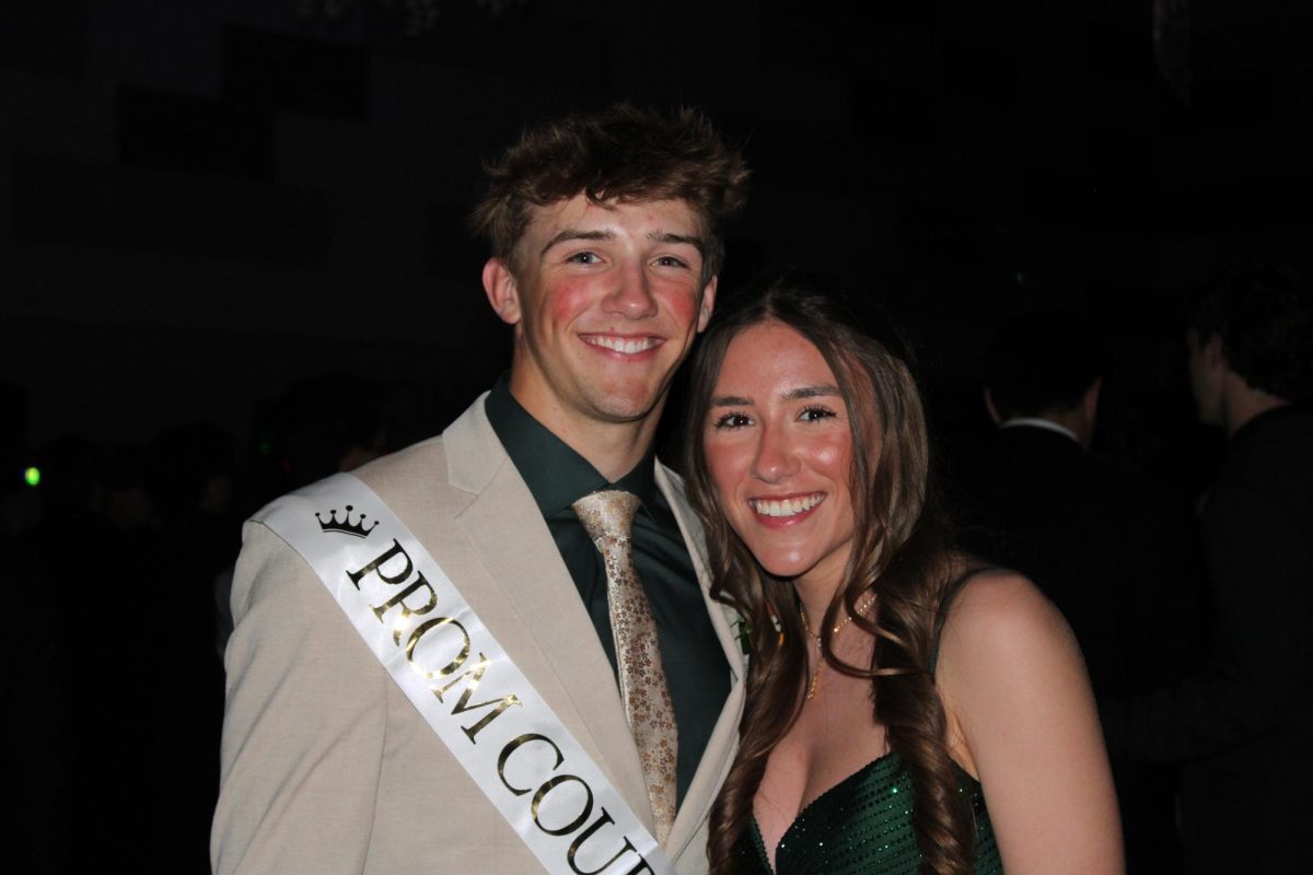 Seniors Mallory Ringenberg and Owen Hess stop to take a picture at prom on April 13, 2024. Both seniors matched in green. 
