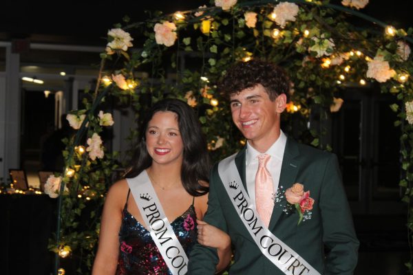 Juniors Chelsea Mahloh and Tyler Neitfeldt enter prom hand-in-hand on April 13, 2024. They danced the night away.
