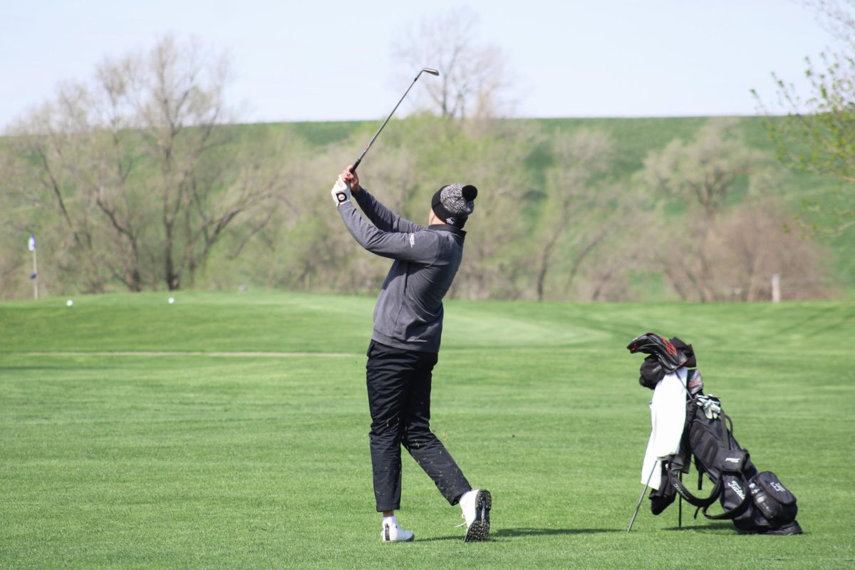 Nathan Kudrna (11) chips on to the green on the ninth hole at the Blair invite on April 19, 2024. He hit his previous drive into the middle of the fairway.