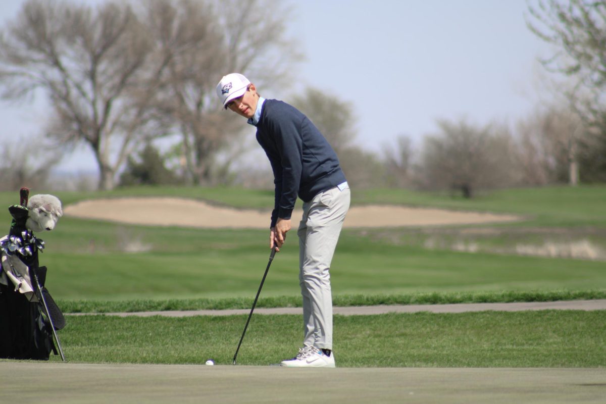 Andrew Nietfeldt (10) hits his putt for birdie on the 18th hole at the Blair invite on April 19, 2024. He then walks back to the clubhouse to turn in his scorecard.