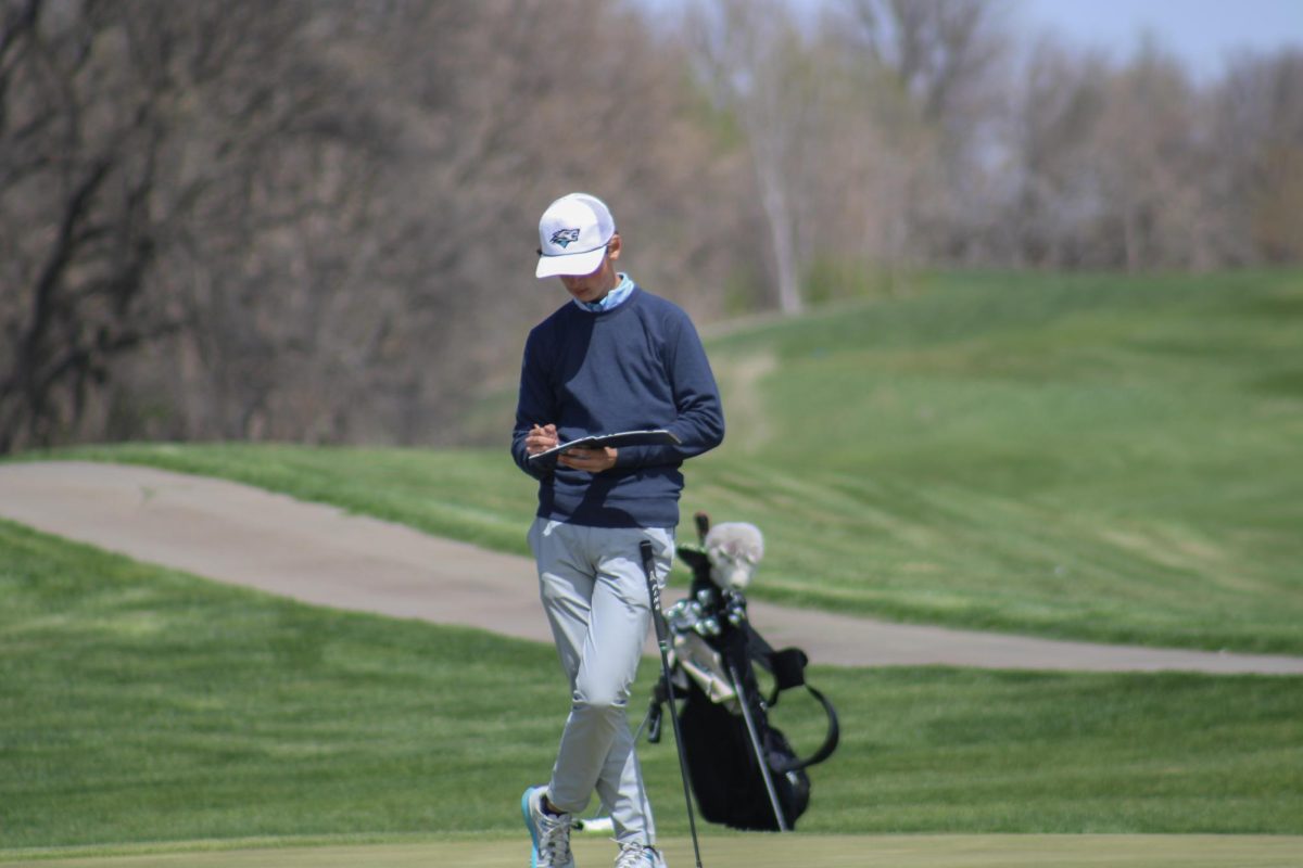 Andrew Nietfeldt (10) writes down his and his opponents score on the 18th green. He finished his round with an 80 and placed 10th at the Blair invite on April 19, 2024.