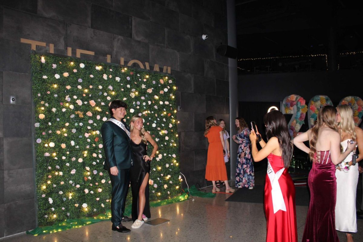 Juniors Johnny Tran and Whitney Carrico pose for a picture taken by junior Sophia Clinkinbeard on April 13, 2024. The background at prom was am attraction for many photos. 