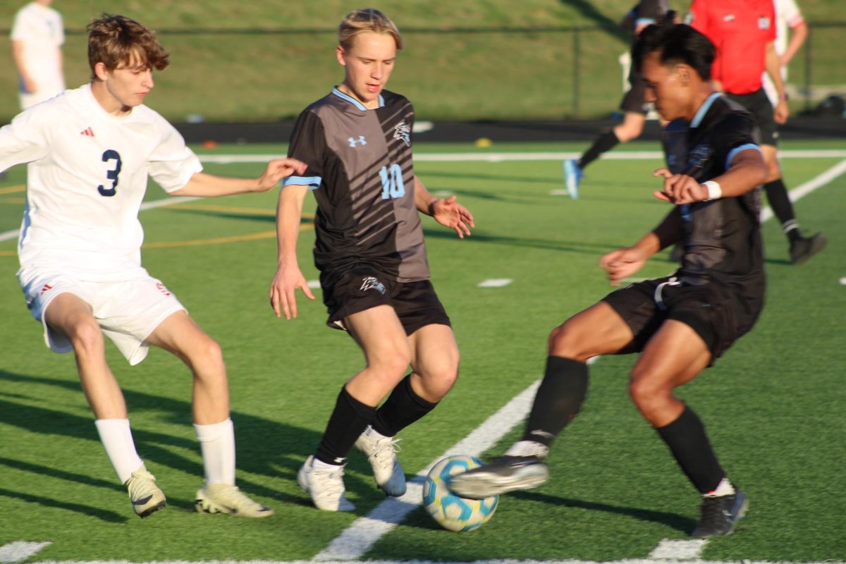 Sophomore Jack Olsen (10) and Junior Van Bik (4) running for the ball. Bik gained possession of the ball at the game on Tuesday, April 23.