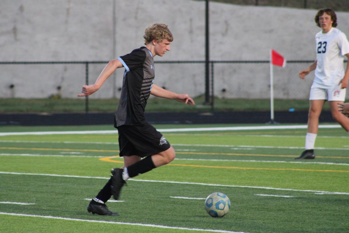 Sophomore Kason Krings (23) kicking the ball in the first half of the game. He made a long pass to a teammate at the game against Norris on Tuesday, April 23rd.