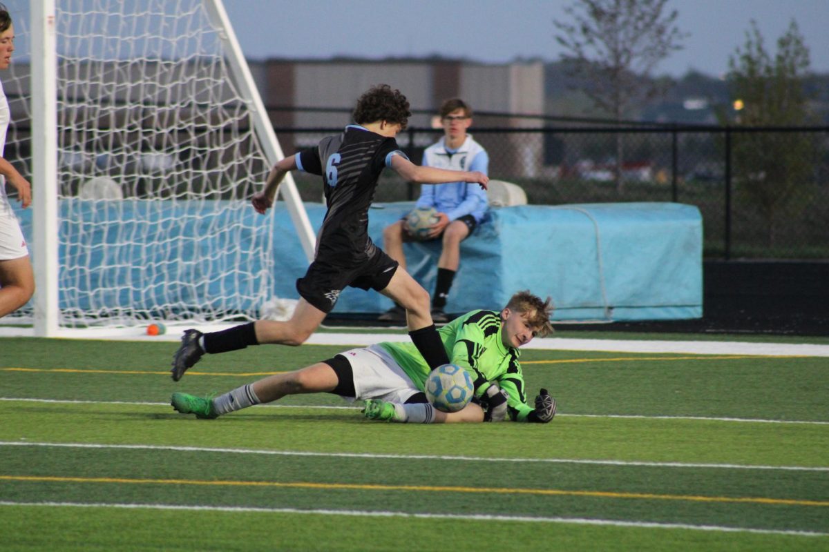 Senior Oliver Lucoff (6) jumping over Norris' Goalie to continue his pursuit of the ball. Lucoff passed the ball and helped score a goal shortly after at the game on Tuesday, April 23rd.