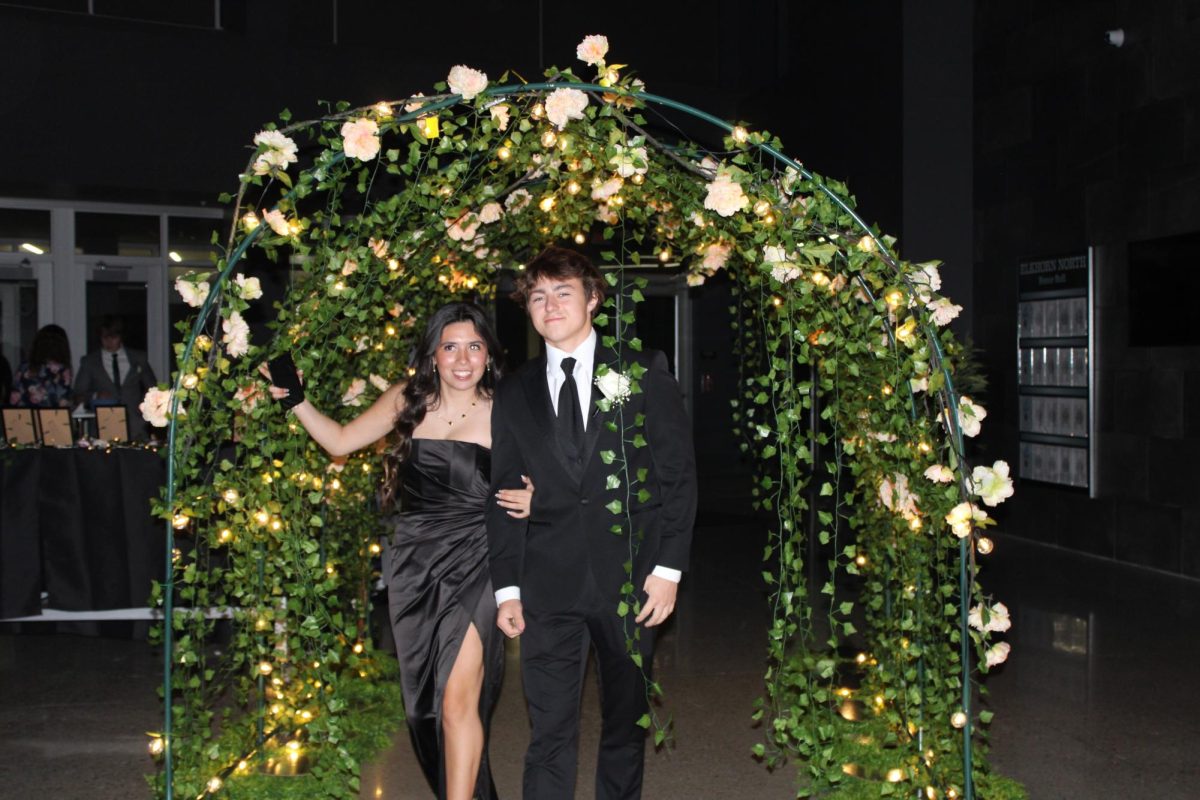 Senior Zac Horner and his date walk into prom together on April 13, 2024. Everybody entering prom walked through a big arch with lights and flowers. 