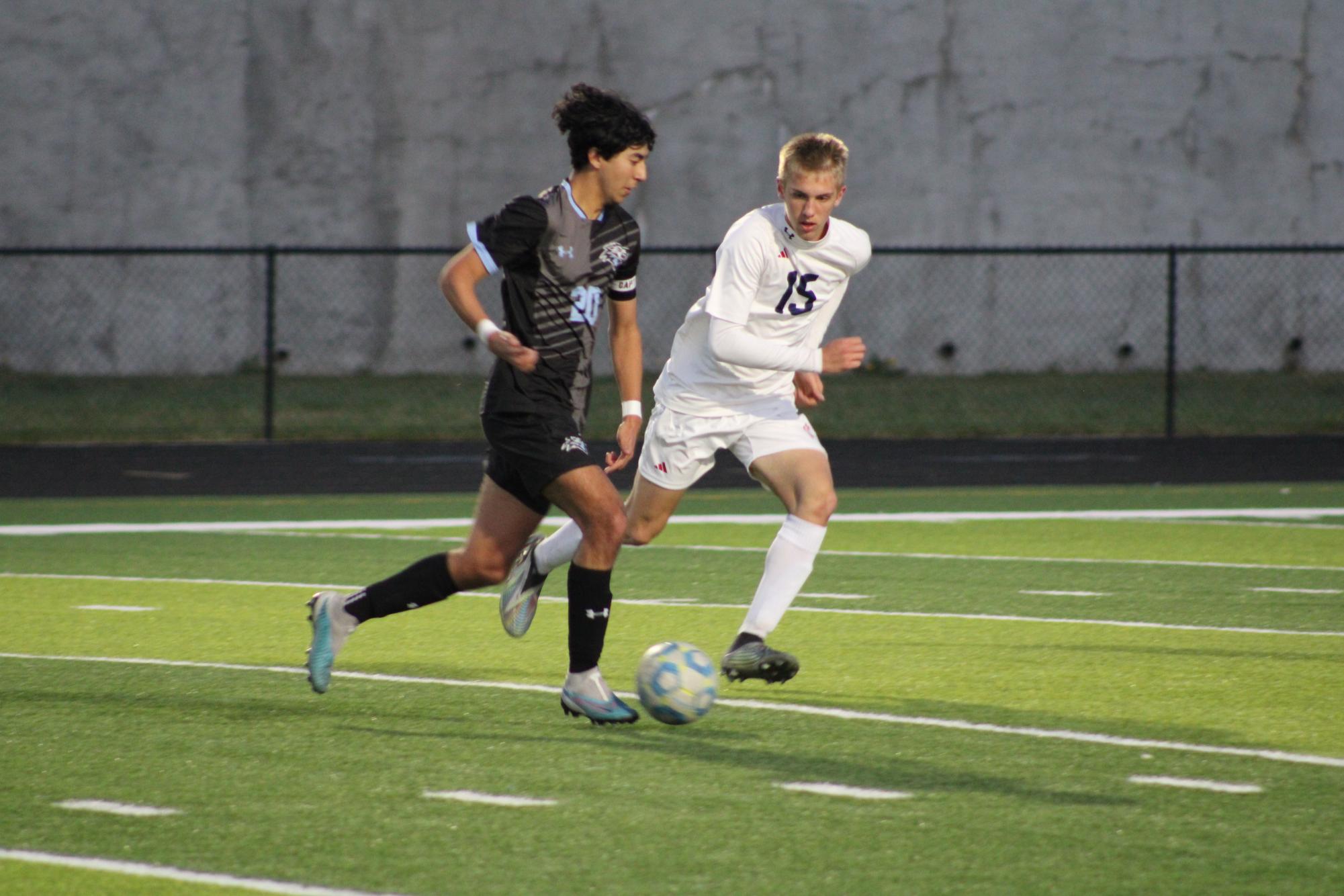 Junior Luke Grigsby (20) dribbling the ball while attempting to keep possession from his Norris opponent. Grigsby got two assists in their game on Tuesday, April 23rd. 