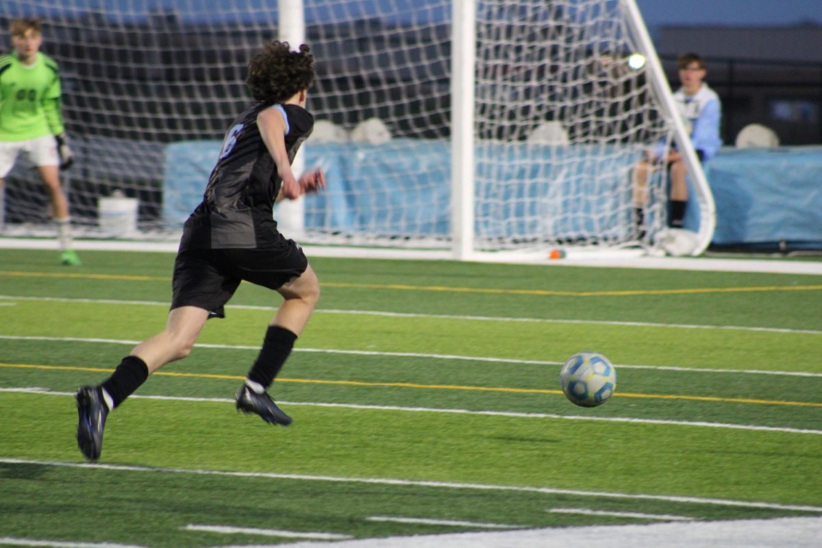 Senior Oliver Lucoff (6) running to hit the ball towards Norris' goal. Oliver assisted in the scoring of a goal during the second half of the game on Tuesday, April 23rd.