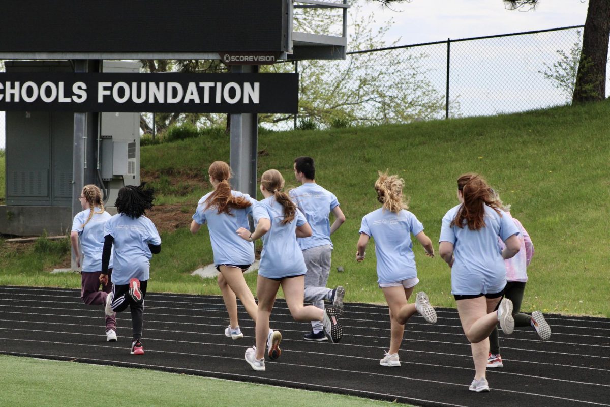 The Speical Olympics group starts running around the track on May 3, 2024. They participate in their last event as they go around the track as many times as they can.