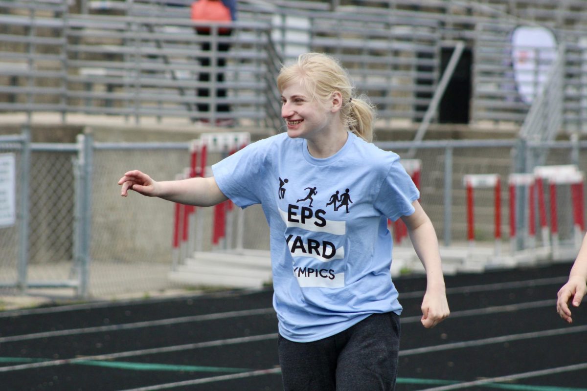 Junior Aubrey Gosh walks around the track on May 3, 2024. Gosh smiles as she goes around.