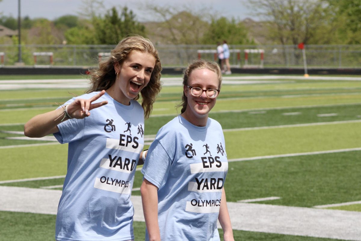 Junior Lexi Wright (left) and Charoltte Kenny (right) posing as they walk by. They complete their fourth lap together on May 3, 2024.