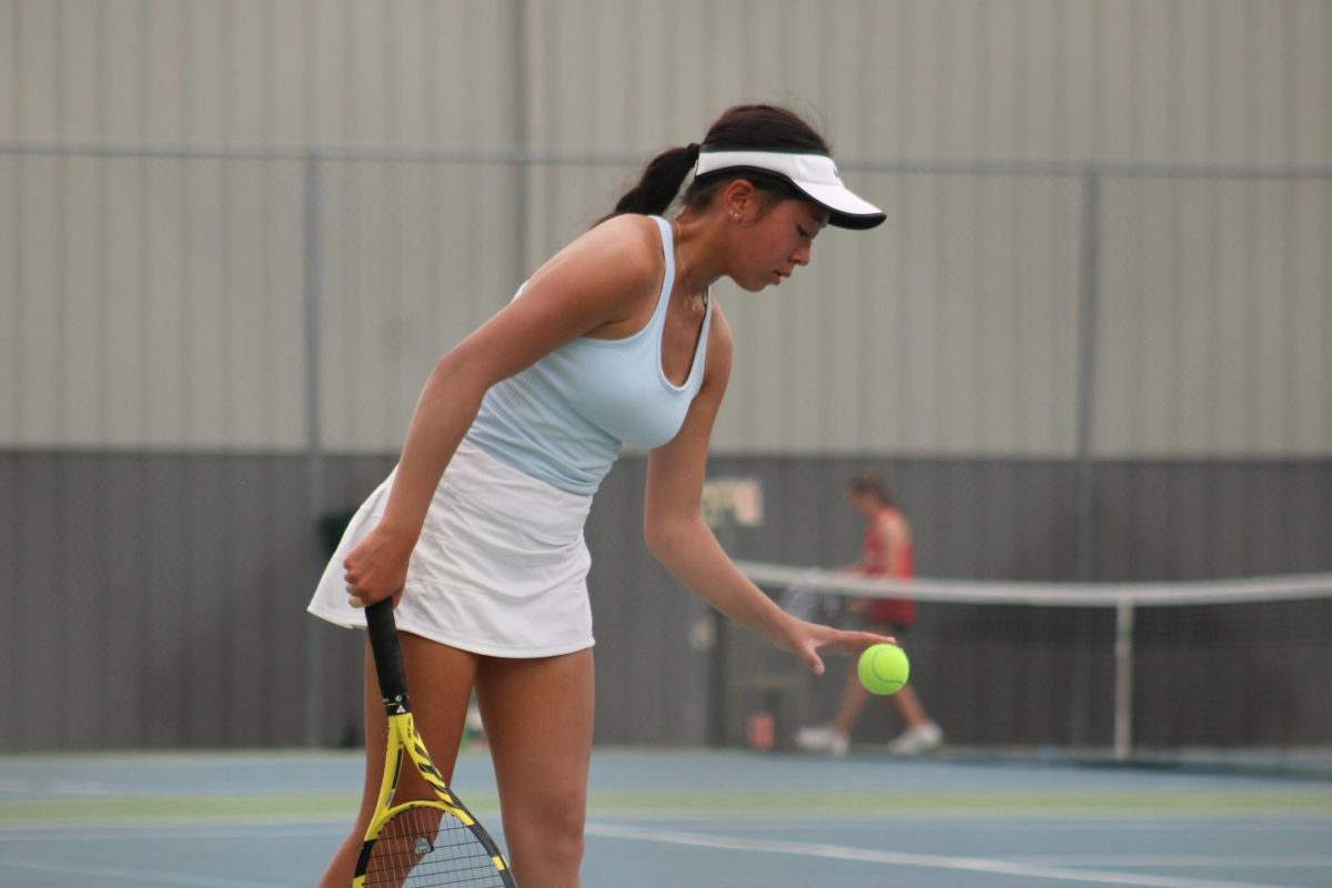 Junior+Sophia+Jones+gets+ready+to+serve+the+ball+in+her+second+match+of+the+day.+She+competed+in+the+Class+B+State+Tournament+Championship+in+May+of+2023.