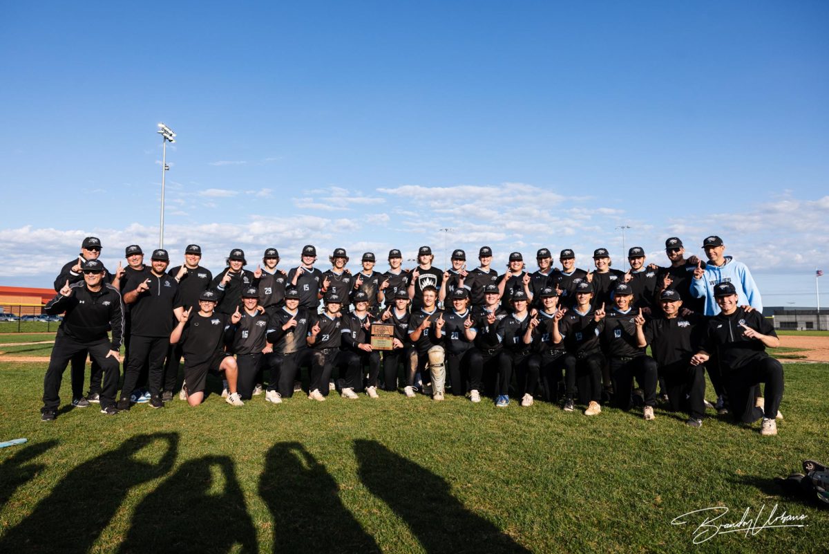 The Elkhorn North baseball team holds the district champion plaque after beating Skutt Catholic. 