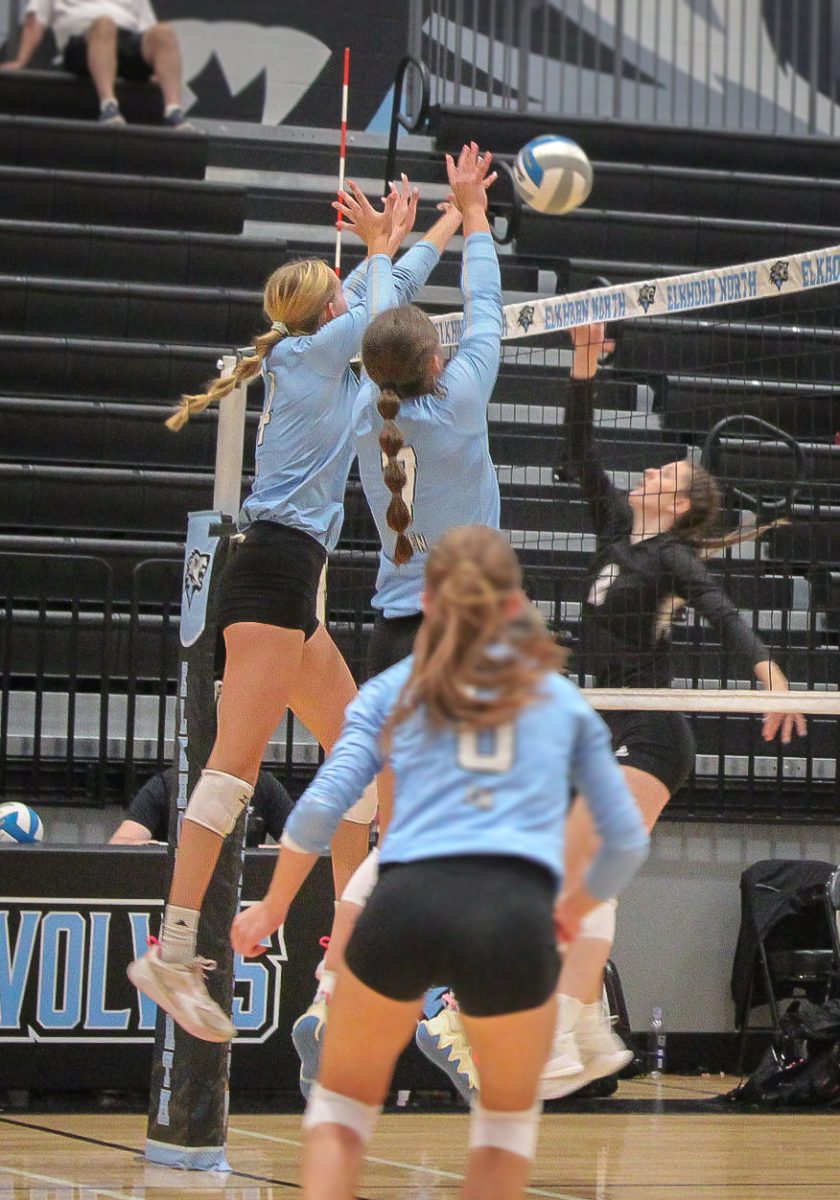 Junior Shay Heaney (4) and Senior Lindsey Hrbek (7) block the ball. Skutt was able to tip the ball, allowing Junior Hayden Booth (6) to get a successful pass.