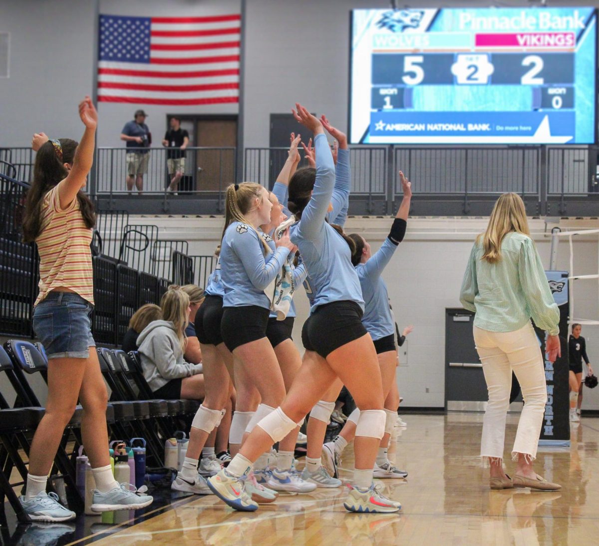 The Wolves sideline celebrates. Reagan Walraff (9) had won the point with a powerful kill.