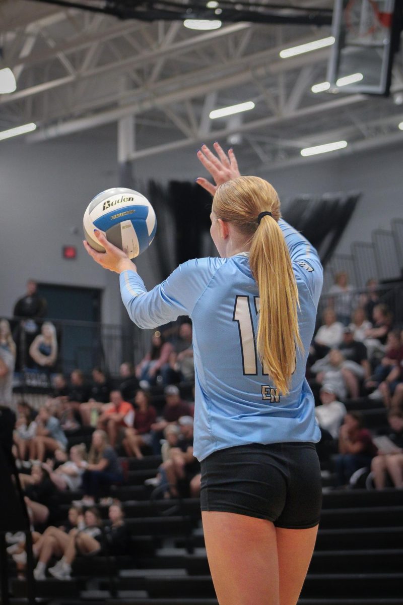 Freshman Payton Palmer (13) gets ready to serve. She won the point with an ace.