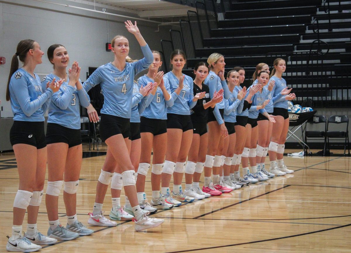 Junior Shay Heaney (4) waves as the Wolves line up and introduces herself. They were looking forward to a good conference match against Waverly.