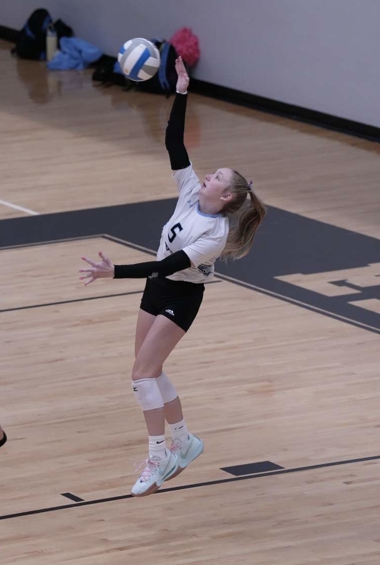 Millie Mauch serving the ball for the Wolves during one of her games. Mauch is one of the best servers on the team with 8.5% of her serves being an ace. Photo Courtesy of Millie Mauch.