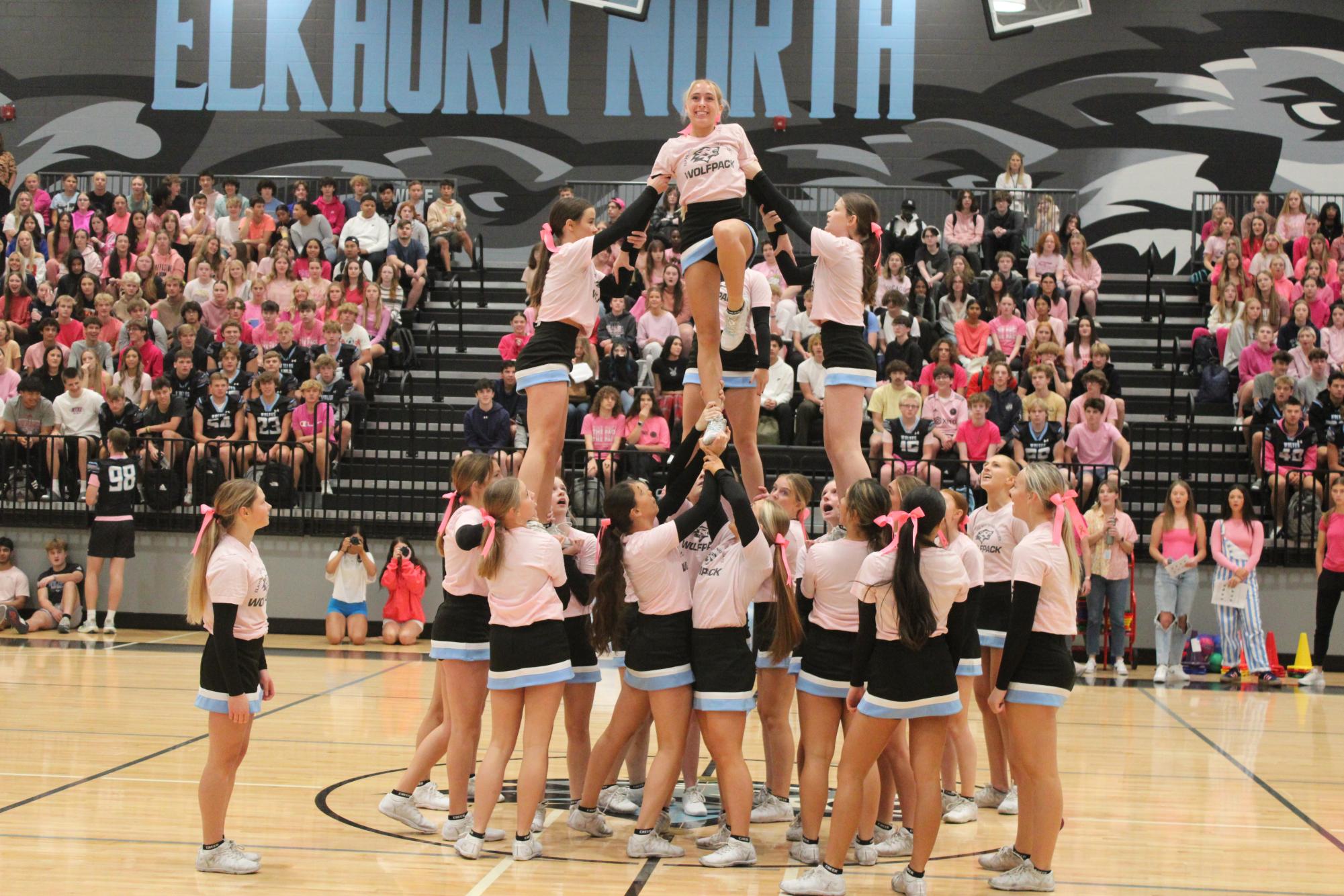 Elkhorn North's cheer team stunts during their pep rally performance. Junior Vanessa Miller is lifted at the top. Miller is the highest cheerleader. 