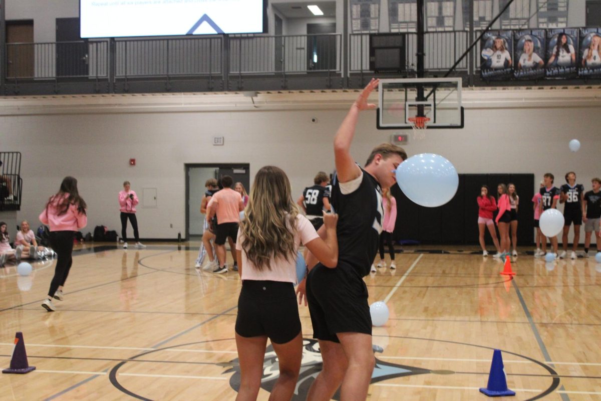 Juniors [left to right] Aubrey Phonephakdy and Asher Christo are the last of the Junior team during the snake game. After trying to save the balloon, Christo gives up and smacks the balloon on the floor. 