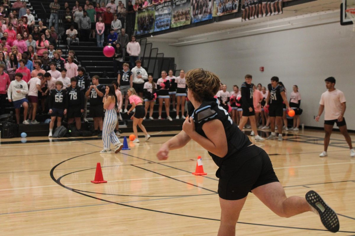 Junior Garrett Ringenberg throws dodgeball at the senior team. Ringenberg misses his target, Sophia Clinkinbeard. 