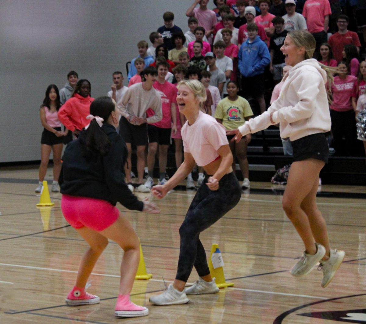 Sophmores [left to right] Ava Newbauer, Addison Bratt, and Katie Clinkinbeard's reactions. Newbauer and Bratt jump for a chest bump because they won dodgeball for their grade.