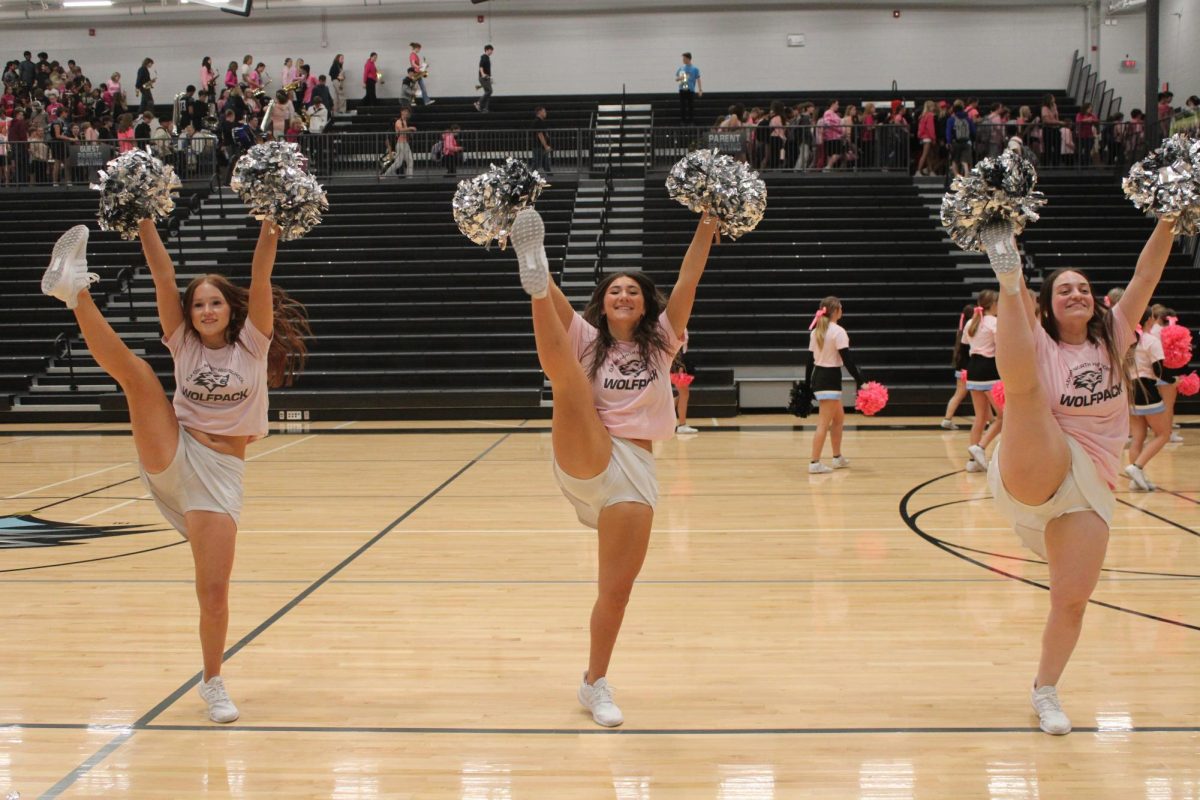 Juniors [left to right] Alison Dixon, Cosette Kaminski, and Kahlen Aurich do a high kick. The dancers did this after the pep rally. 