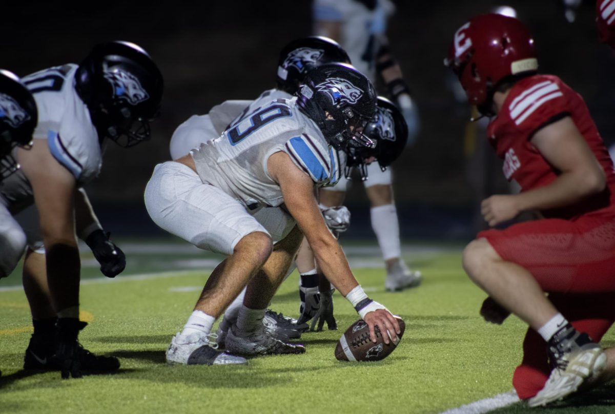 Senior Mason Murphy (59) waiting to snap the ball. Murphy is the center.