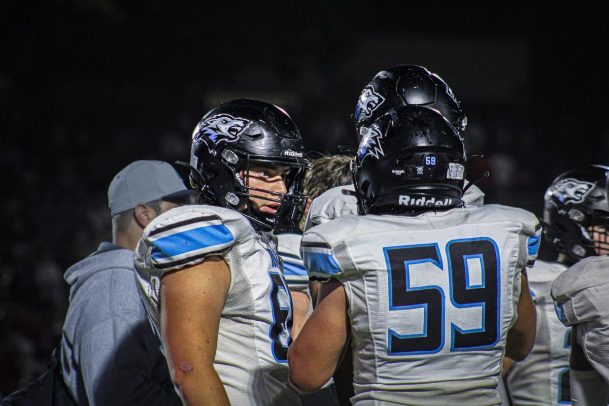 Max Jakob (68) converses with Mason Murphy (59). They start on the offensive line.