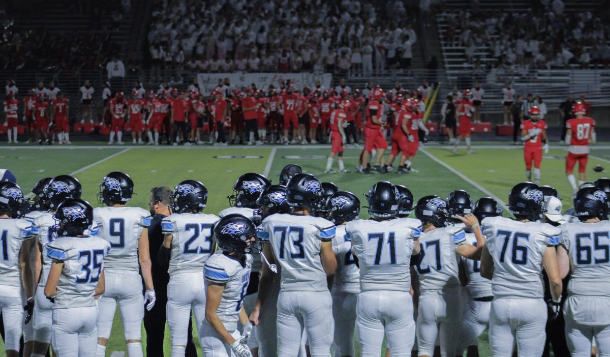 The Elkhorn North Wolves stand on the sidelines across from the Elkhorn High School Antlers. This was Elkhorn High’s Homecoming game, and the Wolves’ first loss of the season.