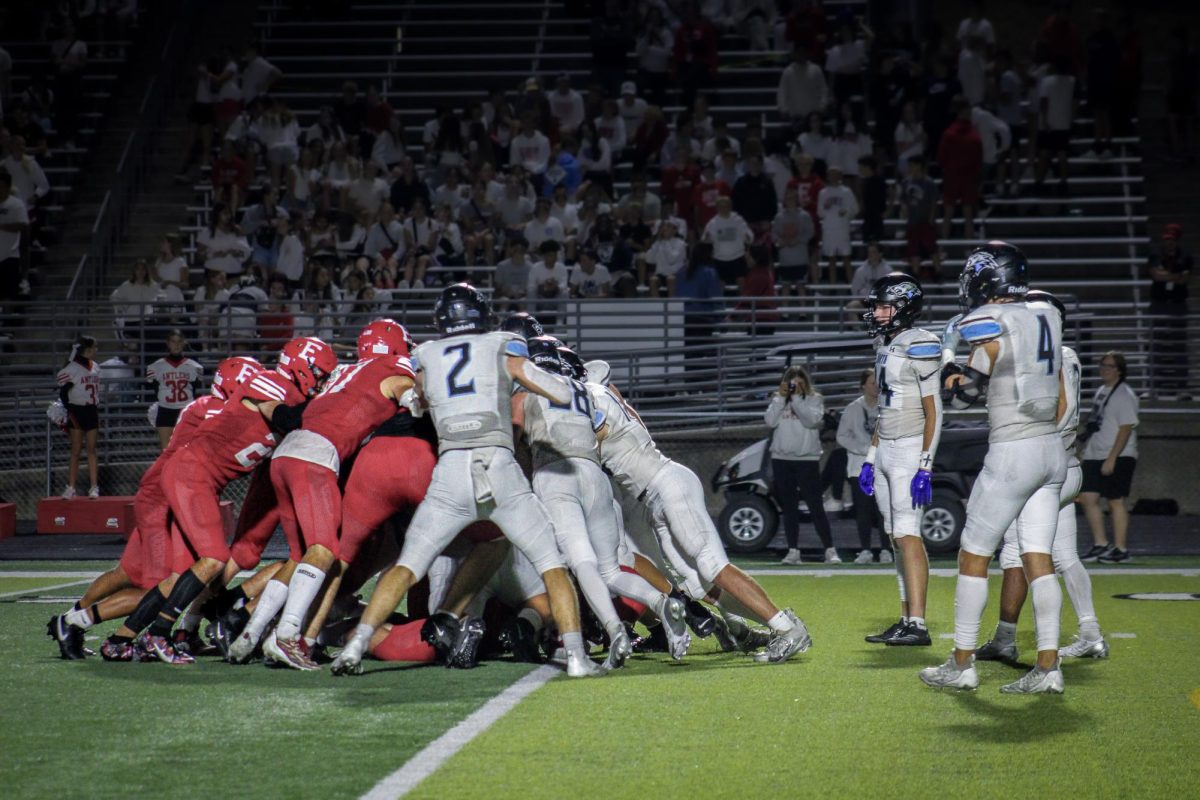 The Wolves and Antlers pile on each other. Kendall Gragert (14), Junior Alex Uchtman (4),and  Jett Tingelhoff (7), were standing to the side.