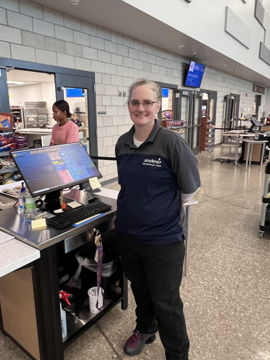 McNat is displaying kindness to students in the checkout line. Cashiering is her favorite part of the job. 