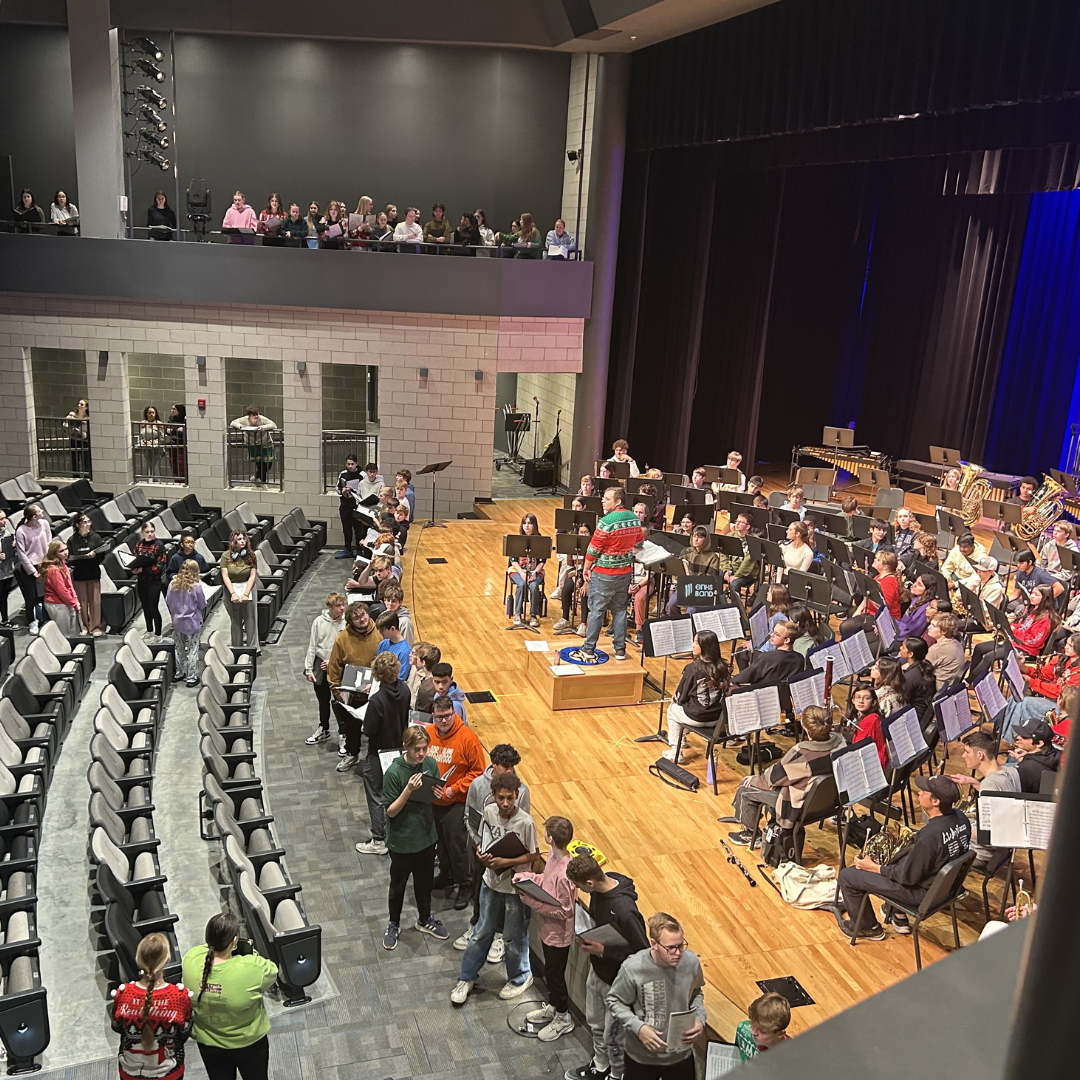 Elkhorn North choirs and concert band rehearse together during TA on December 17th. They are rehearsing to perform a combined piece, “The Promise of Living”, at their annual winter concert. Photo by Amina Teri.