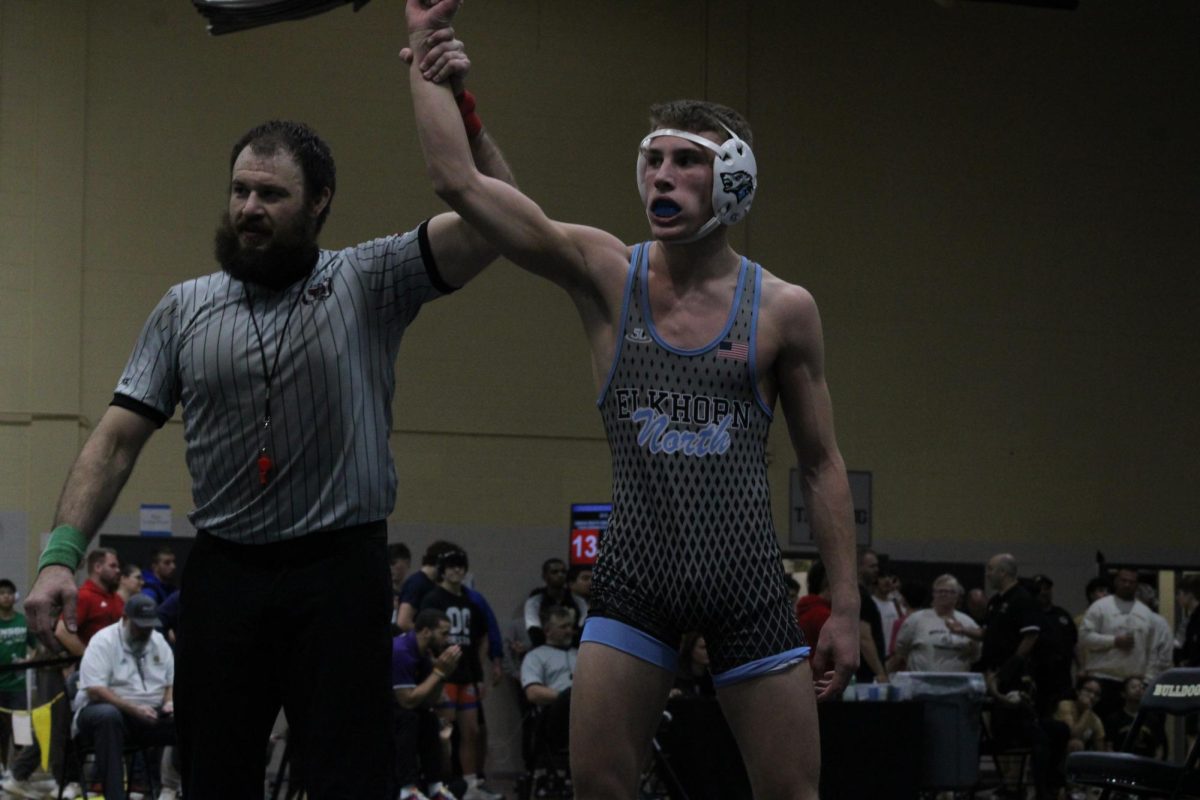 Freshman Steen Christensen wins his first wrestling tournament. The referee held up Christensen's hand indicating to the crowd that he was the winner. 