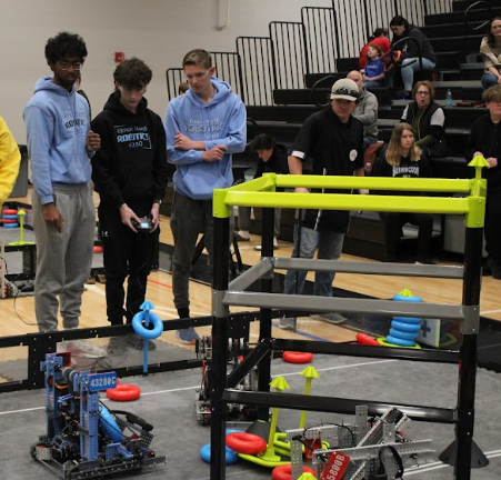 Juniors Sai Smaran  Arevetti, Zane Larson, and Carter Theis operating their robot at competition. This took place at a robotics competition at Elkhorn North, where this team placed in competition. 