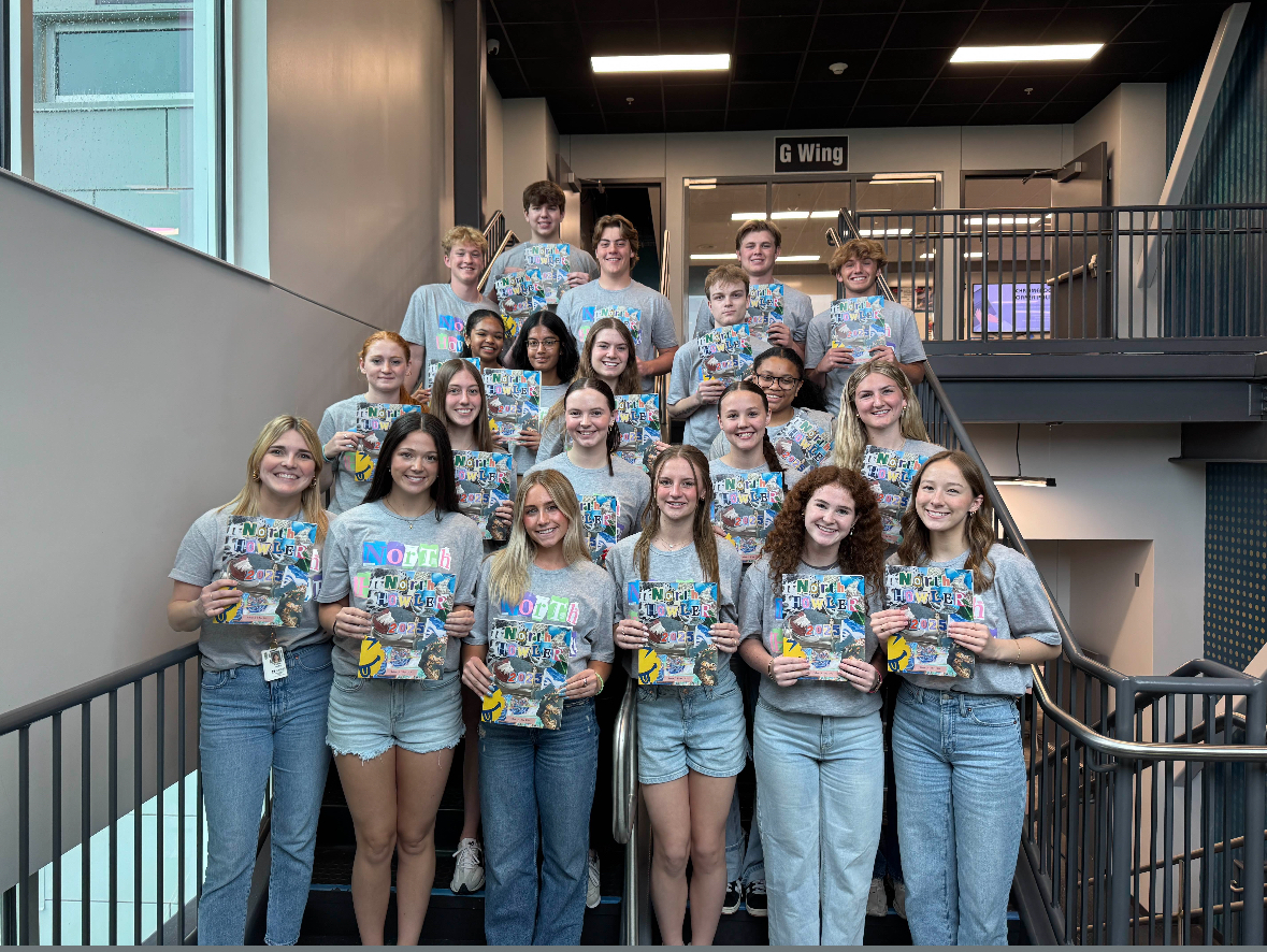 The newspaper staff posed for a picture with the new 2025 print issue. They passed them out to the students at lunch that hour.