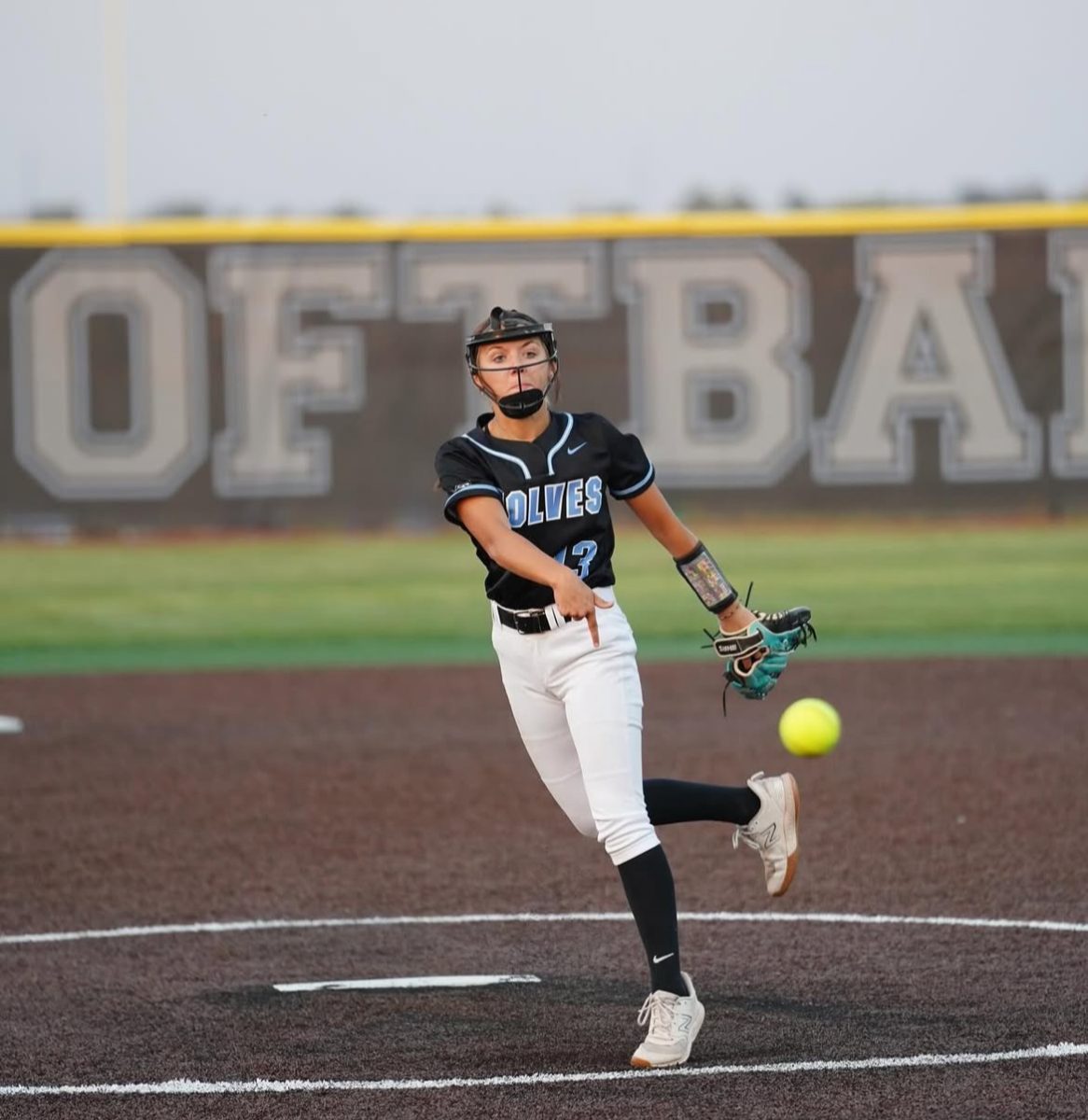Paige Asher delivering a pitch in a softball game. She pitched her first season on varsity her freshman year. Photo courtesy of Paige Asher. 