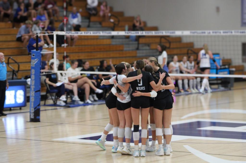 Elkhorn North volleyball players come to the center of the court to celebrate. It was set two in a tough game against Papillion La Vista South and they had just won the point. Photo Courtesy of Brendon O'Dell