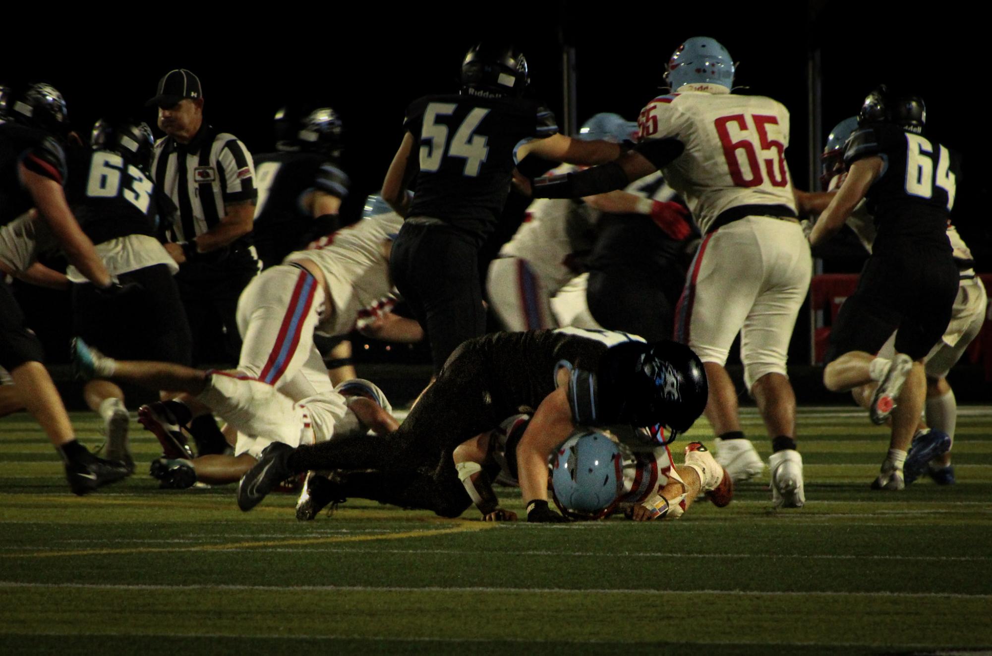 Senior offensive linebacker Shane Heida tackles a Ralston player. Heida had 3 pancake blocks against the Rams.