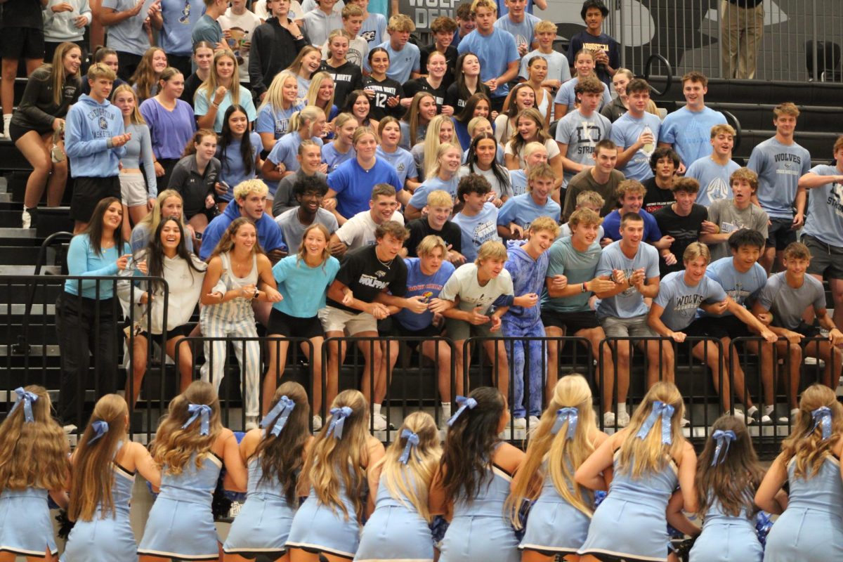 The Pack and members from the cheer team perform a chant. It was during a timeout with the Wolves volleyball team in the lead against Elkhorn High.