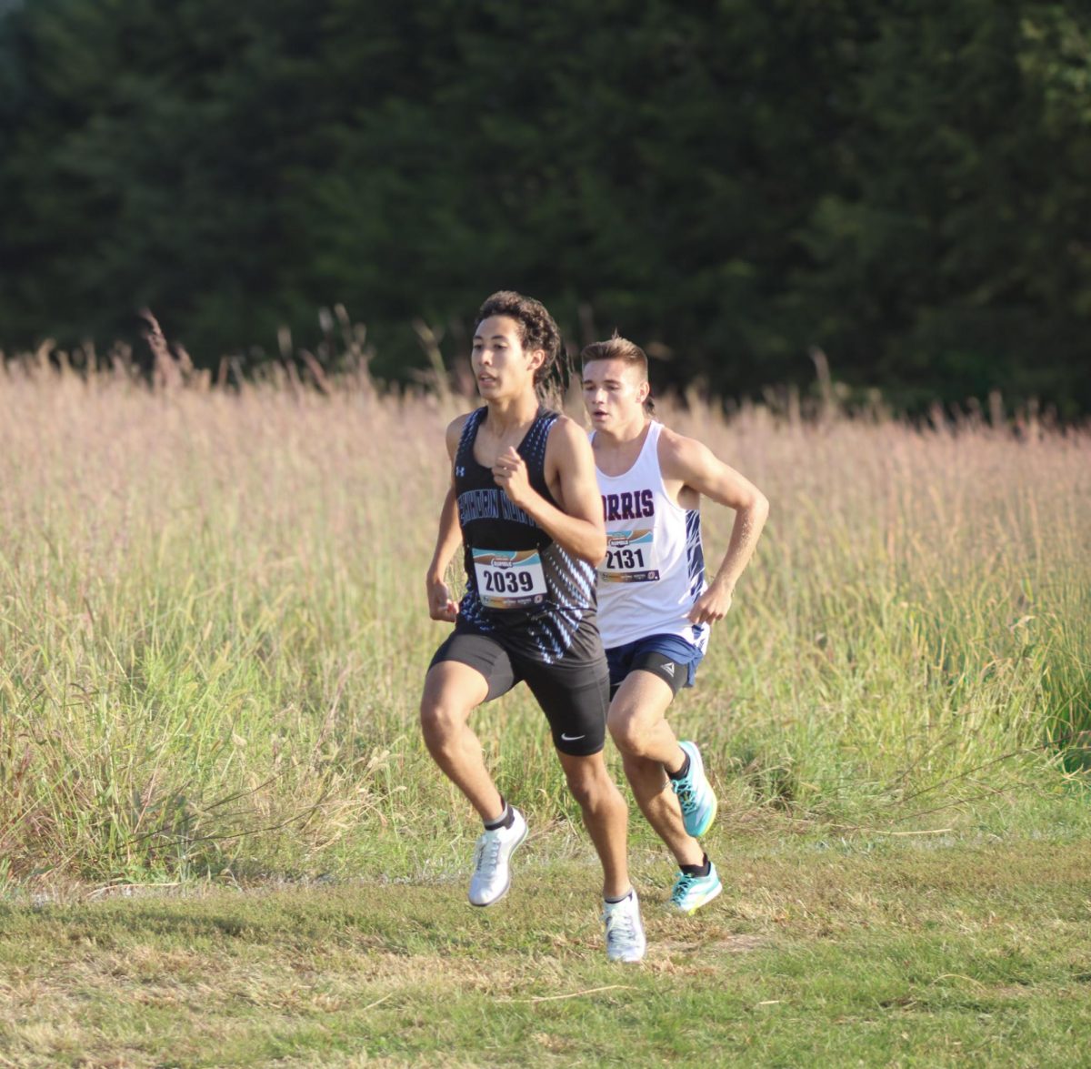 Senior Derek Rieck-Capellan maintains a steady pace while running the first 1K. Rieck-Capellan ended up earning a new personal best and school record with a time of 16:17.54.