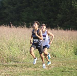 Senior Derek Rieck-Capellan maintains a steady pace while running the first 1K. Rieck-Capellan ended up earning a new personal best and school record with a time of 16:17.54.