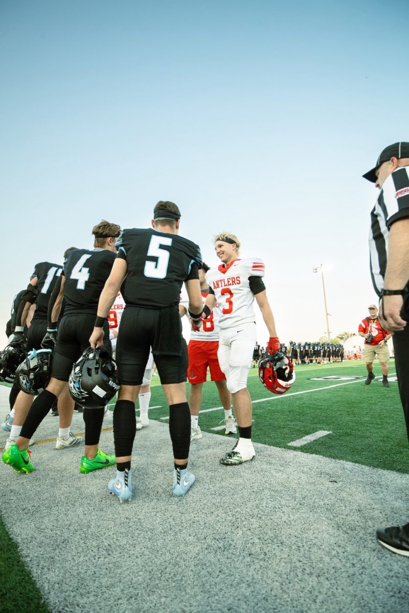 Elkhorn North and Elkhorn High team captains shake hands before the game. The strange occurrence of two teams sharing a home field has made a victory in this rivalry very important. Photo courtesy of Brody Pruss.