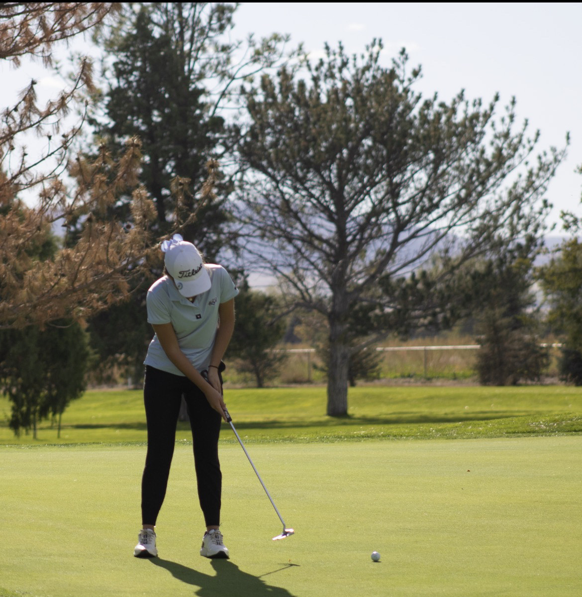 Avery Peter rolls a putt towards the hole. On October 13-14, the Elkhorn North golf team competed in the state tournament.