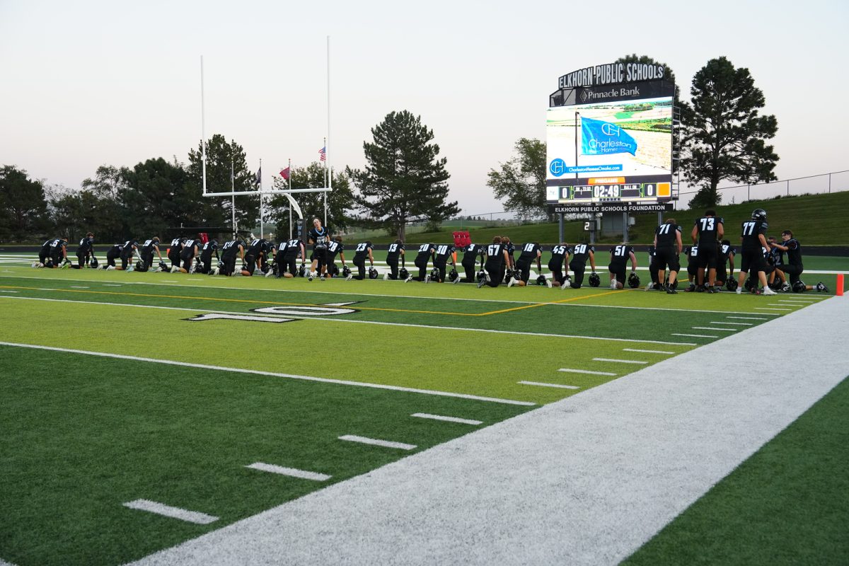 Football players praying at the end zone at their game against Elkhorn High on October 3rd. Every game there are more players who join this pre-game routine. Photo courtesy of Renee Vokt.