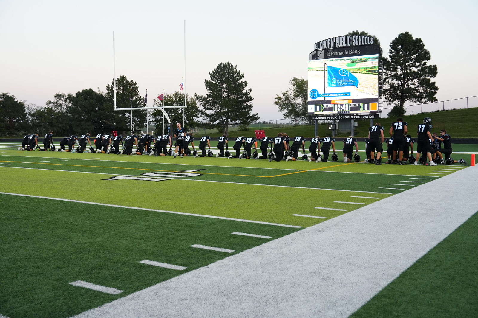 Football players praying at the end zone at their game against Elkhorn High on October 3rd. Every game there are more players who join this pre-game routine. Photo courtesy of Renee Vokt.