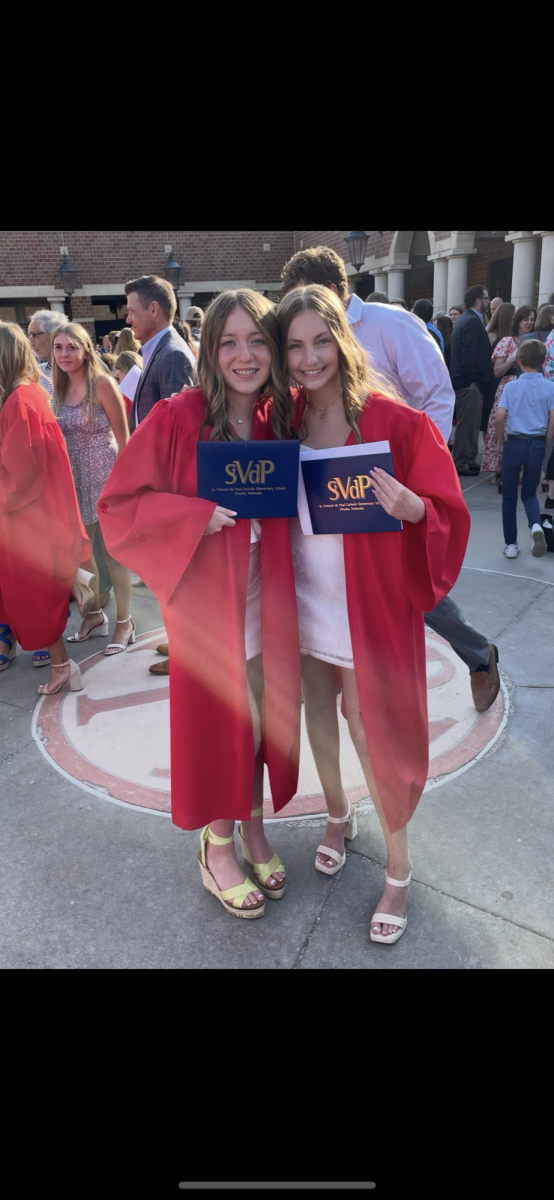 Junior Hannah Skudlarek at her 8th grade graduation. Skudlarek went to St. Vincent de Paul and is posed in the picture with one of her classmates. 